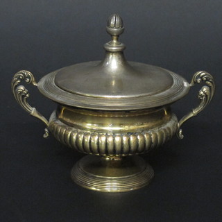 A circular Continental silver gilt twin handled urn and cover with demi-reeded decoration, raised on a circular spreading foot, the  base marked 800 176F  ILLUSTRATED