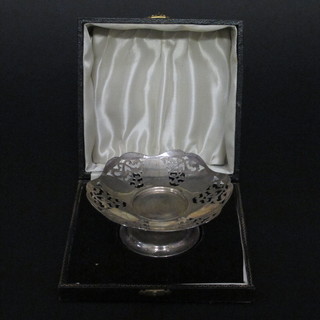 A circular pierced silver pedestal dish Birmingham 1943, 2 ozs, cased and 2 silver napkin rings