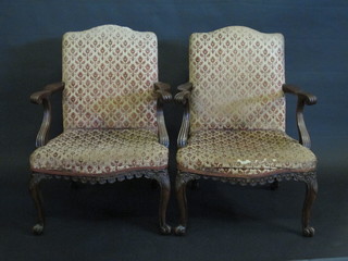 A pair of Georgian style winged walnut open arm library chairs