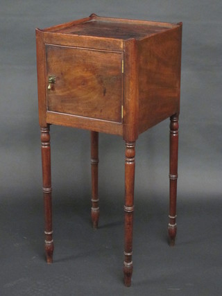 A 19th Century mahogany square bedside cabinet with dish top,  enclosed by a panelled door, raised on turned supports 14"