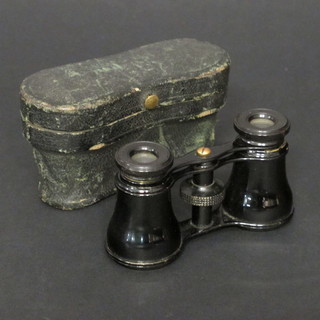 A pair of opera glasses with leather carrying case