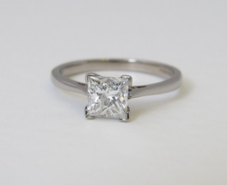 A lady's 18ct white gold dress/engagement ring set a square  Princess cut diamond, approx 1.12ct together with Anchor  certificate