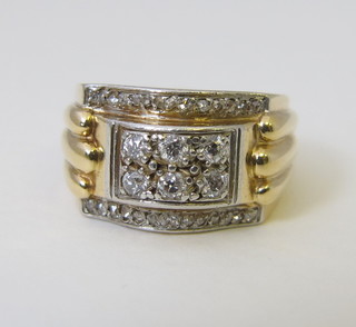 A yellow metal dress ring set diamonds