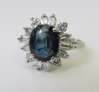 A 14ct white gold dress ring set an oval cup sapphire supported  by diamonds