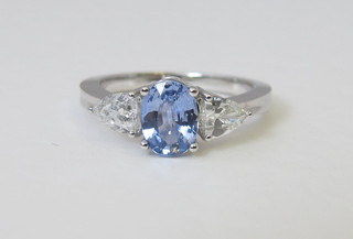 An 18ct white gold dress ring set a sapphire approx 1.20ct, supported by 2 diamonds approx 0.74ct