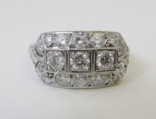An Art Deco style 18ct white gold dress ring set 3 diamonds, surrounded by diamonds, approx 1.30ct