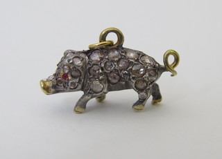 A gold pendant in the form of a pig set diamonds and with ruby eye