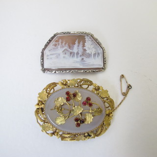A pierced gilt metal brooch and a shell carved brooch