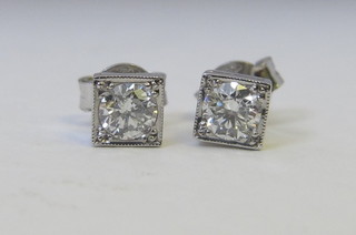 A pair of square diamond set ear studs, approx 0.60ct