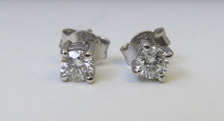 A pair of circular diamond set ear studs, approx 0.58ct