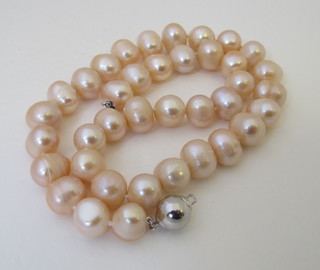 A rope of pink pearls with silver clasp