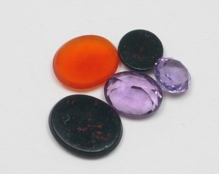 2 oval amethyst coloured stones, an oval bloodstone, a circular bloodstone and 1 other hardstone