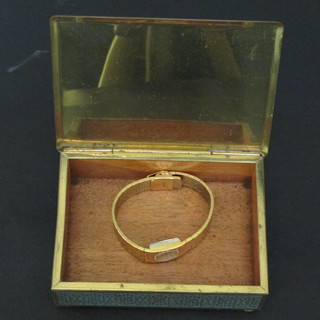 A gilt trinket box with hinged lid and a lady's gilt cased  wristwatch