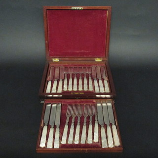 A set of 12 Victorian silver plated fruit knives and forks with mother of pearl handles contained in a mahogany canteen box