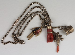 A coral charm in the form of a hand, do. rattle and 2 other charms and a gilt metal belcher link chain