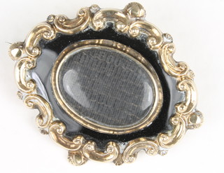 A gilt metal mourning brooch