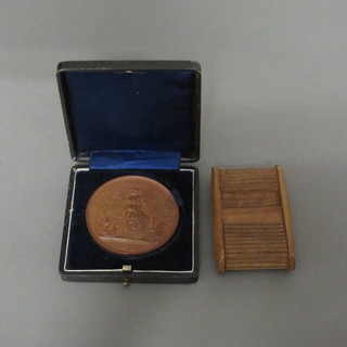 A bronze medallion 1885, together with a wooden shuttered vesta  case