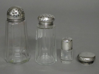 A cylindrical cut glass sugar sifter with silver lid, 1 other, a  small salts bottle with embossed silver lid and a silver plated lid
