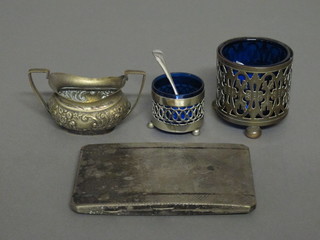 2 circular pierced silver plated salts with blue glass liners, a silver plated salt and a silver plated cigarette case