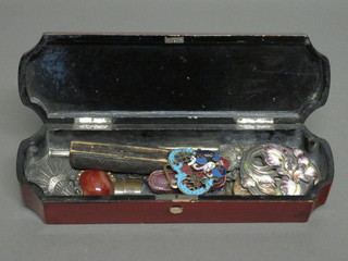 An Oriental rectangular lacquered glove box with hinged lid  containing a collection of costume jewellery, buckles, etc