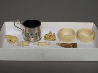 A pair of carved ivory napkin rings, a horn whistle, 3 carved figures and a silver plated mustard pot