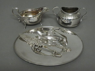 A circular silver plated dish, a silver plated sauce boat etc