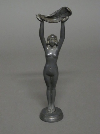 A metal figure of a standing lady 9"