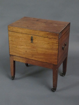 A Georgian rectangular inlaid mahogany cellarette with brass drop handles, raised on square tapering supports ending in brass  caps and castors 18"  ILLUSTRATED