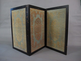 An ebonised 3 fold draft screen with machine made panels