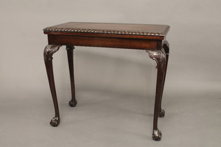 An Edwardian Georgian style rectangular mahogany card table with gadrooned border, raised on cabriole ball and claw supports  33"