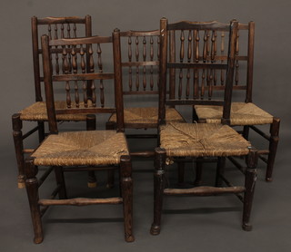 A set of 5 Lancashire spindle back dining chairs with woven rush seats