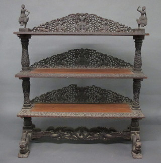 An Anglo Indian hardwood 3 tier buffet, heavily carved  throughout and raised on chindit style supports 48"   ILLUSTRATED