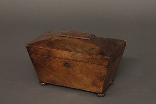 A 19th Century mahogany sarcophagus shaped tea caddy with  hinged lid, raised on bun feet