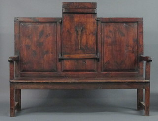 An 18th/19th Century elm settle with raised panelled back incorporating a folding table to the centre, raised on square  supports 75"
