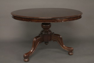 A circular Victorian mahogany snap top Loo table, raised on  a pillar and tripod base 45"