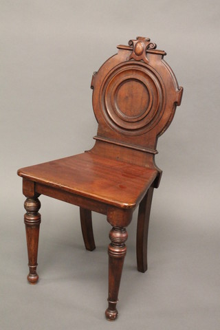 A Victorian mahogany hall chair with solid seat, raised on turned supports