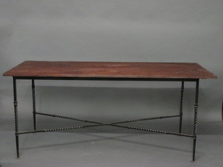 A rectangular rustic table, raised on wrought iron supports with  X framed stretcher 66"