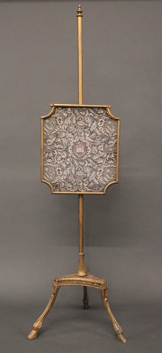 A 19th Century gilt pole screen with shaped banner, raised on a triform gilt base