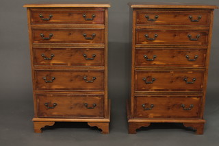 A pair of Georgian style yew chests of 5 long drawers with brass  swan neck drop handles, raised on bracket feet 22"