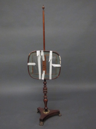 A 19th Century mahogany pole screen with oval glass banner,  raised on a turned column with triform base