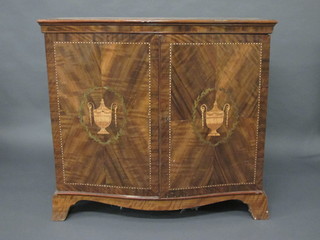 A parquetry cabinet of serpentine outline enclosed by panelled doors, inlaid a lidded urn, raised on bracket feet, 44"   ILLUSTRATED