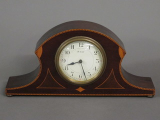 A 1930's 8 day bedroom timepiece with enamelled dial and  Arabic numerals contained in an arch shaped inlaid mahogany  case