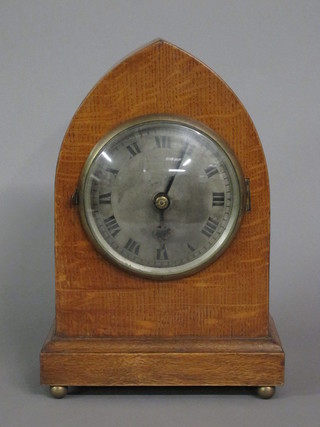 An 8 day striking bracket clock with silvered dial and Roman numerals contained in an oak lancet case  ILLUSTRATED