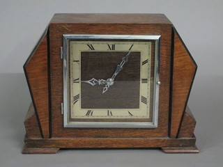 An Art Deco electric chiming mantel clock with square dial, contained in an oak case
