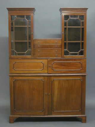 A Georgian style mahogany cabinet fitted 4 long drawers flanked by 2 cupboards with moulded cornices, the interior fitted  adjustable shelves enclosed by astragal glazed panelled doors, the  base fitted 2 cupboards enclosed by panelled doors, raised on  bracket feet, made by Pragnell & Co of 58 East Street, Horsham  together with a reference 45"