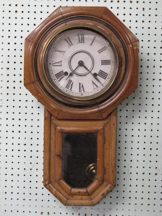 A striking Ansonia wall clock with paper dial and Roman  numerals, contained in a walnut case