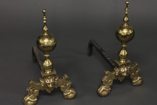 A large pair of brass and iron Dutch style fire dogs
