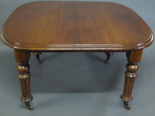 A Victorian mahogany extending dining table with 1 extra leaf, raised on turned and fluted supports