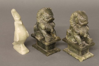 A pair of green carved soap stone figures of Dogs of Fo 8" and 1 other of a bird 7"
