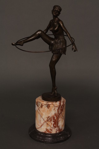 An Art Deco style bronze figure of a standing dancing girl with  hoop, raised on a circular marble base 20"
